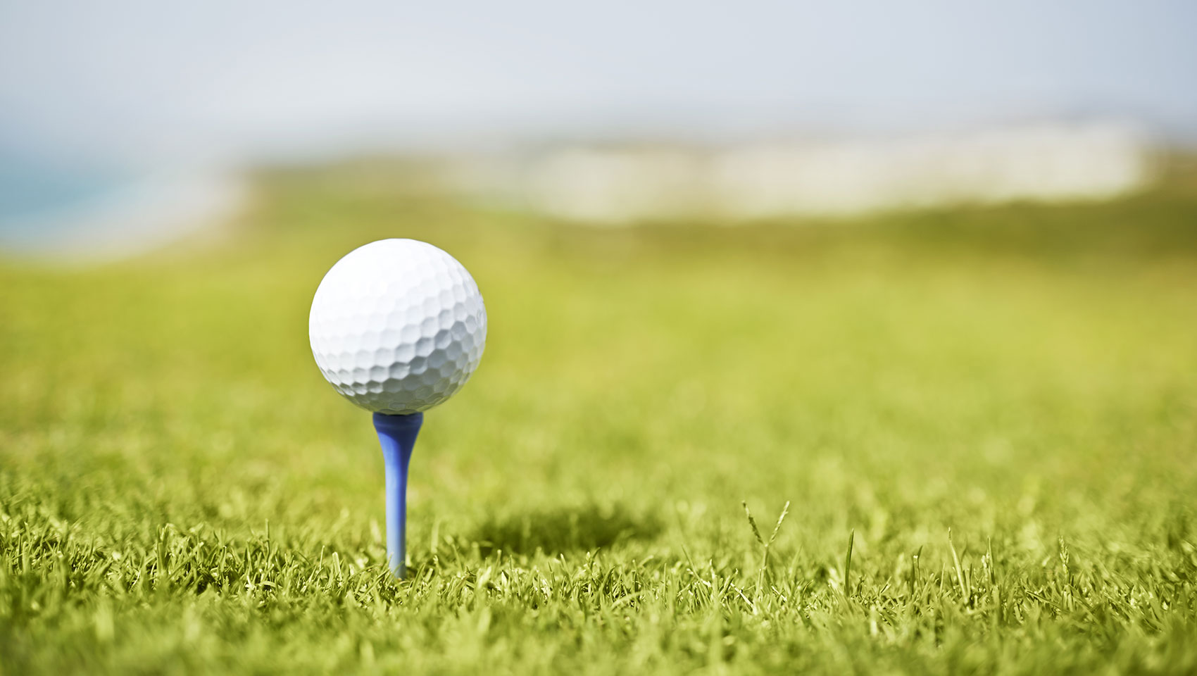 Golf ball on a tee on a golf course