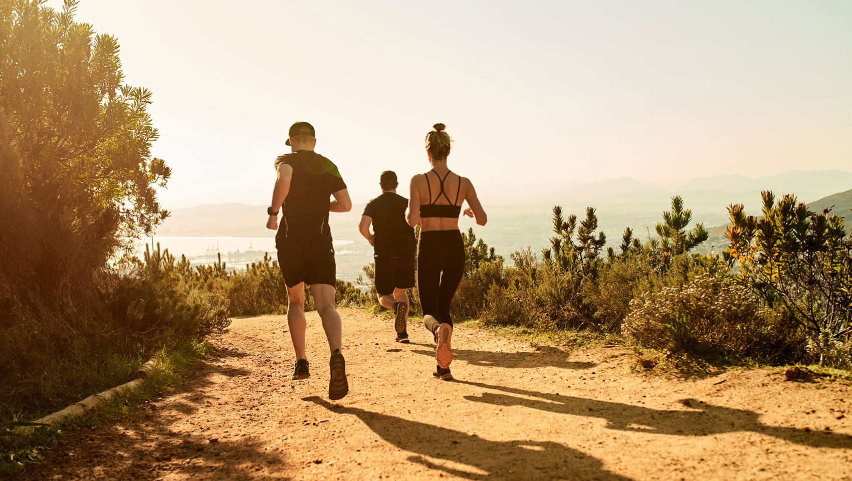 Runners on a desert mountain trail