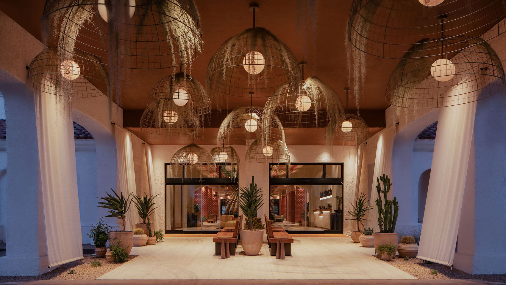 Kimpton Miralina resort entrance with contemporary desert architecture and warm lighting