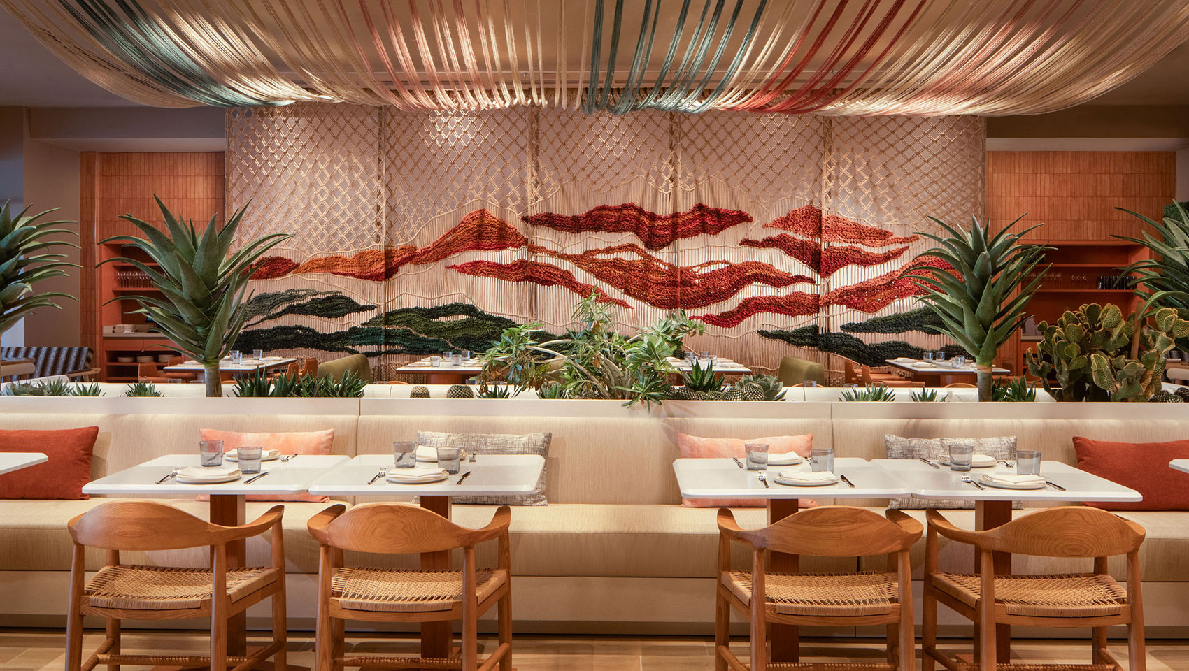 Kimpton Miralina dining room with contemporary lighting, wood details, and elegant table