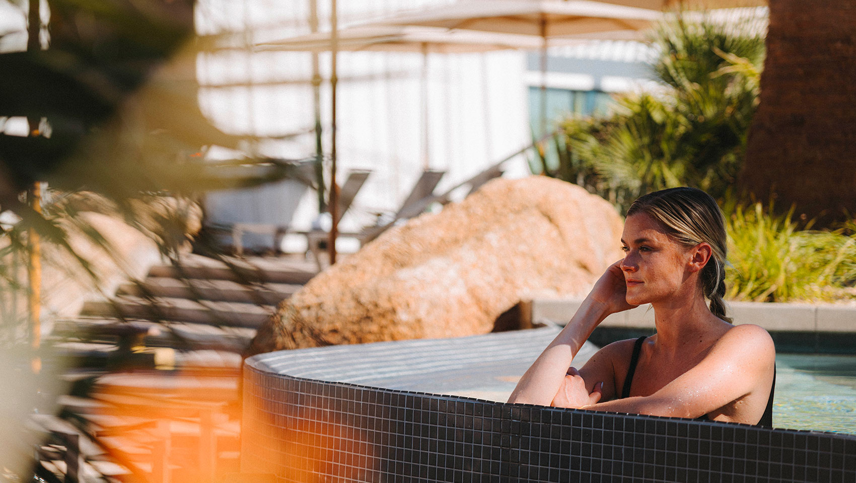 Woman in outdoor hot tub at Miralina 