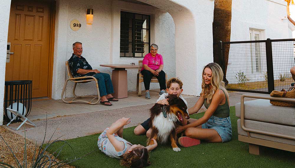 family playing with dog outside canyon casita at Kimpton Miralina
