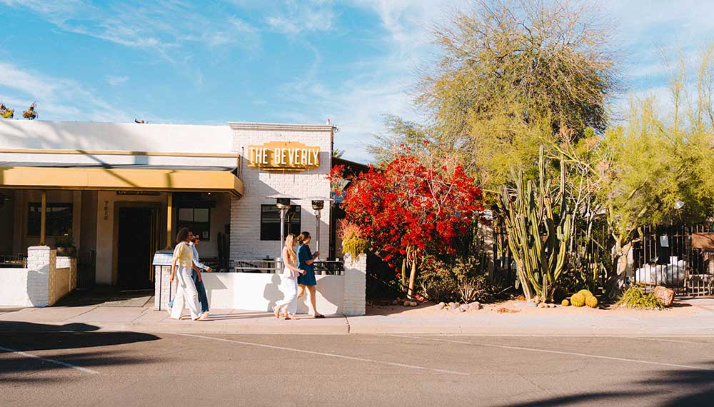women walk in front of The Beverly, a restaurant