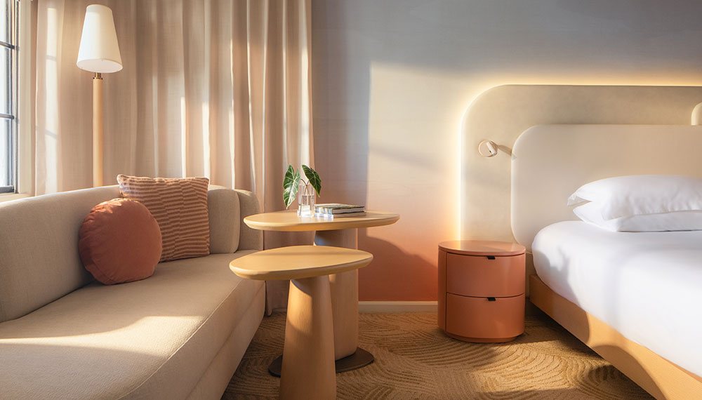 Kimpton Miralina Resort Guestroom bed and side table and chair