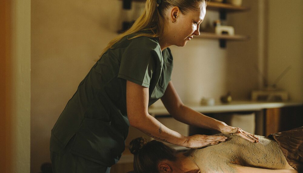 Guest getting mud massage at Kimpton Miralina