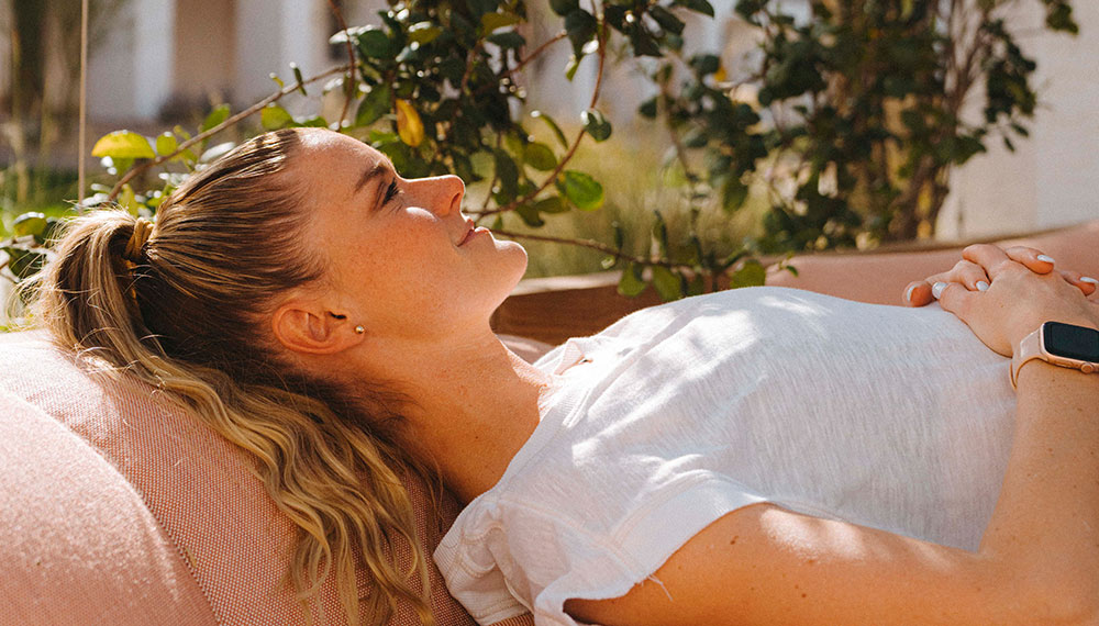 Woman relaxing on outdoor lounger
