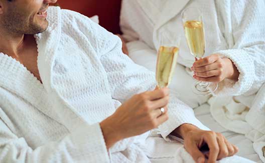 Couple in robes with champagne
