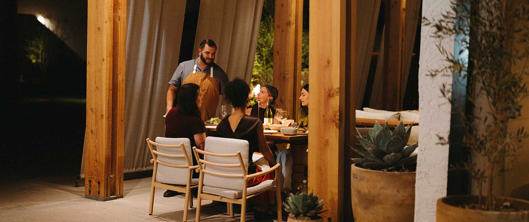 waiter serves table of women at Hecho Libre
